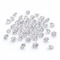 Small moissanite stones scattered on a white background